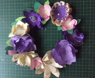 Creating a simple spring wreath out of recycled paper flowers.